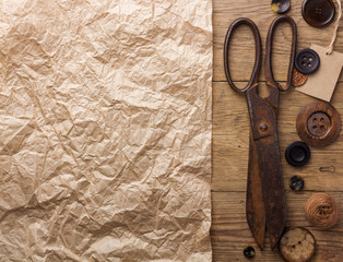 Old scissors and buttons on the wooden table