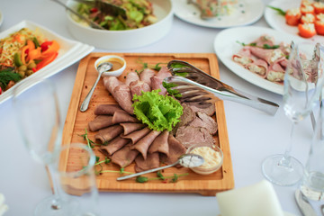 Close up delicious meat cutting on wooden plate on table in selective focus.