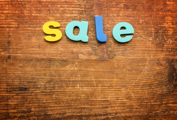 The word SALE written on wood