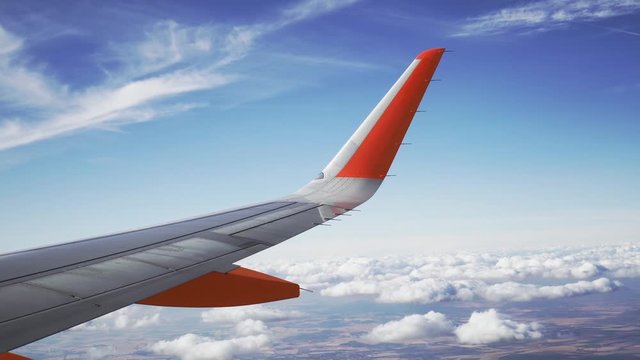 Airplane Flying Above Clouds, stable shot of wing