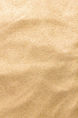 Fototapeta na wymiar Closeup of sand pattern of a beach. Summer background.
