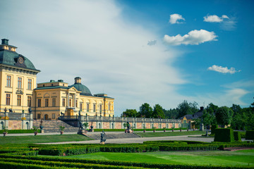 Obraz premium Drottningholm Stockholm, Sweden - Jul 7, 2017: The Drottningholm Royal Palace landscape view from the garden in beautiful sunlight blue sky day.