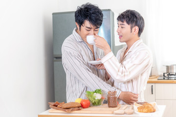 Obraz na płótnie Canvas Asian gay couple homosexual cooking together in the kitchen prepare fresh vegetable make organic salad healthy food. Asian people happy time smile, laugh in kitchen. LGBTQ relation lifestyle concept