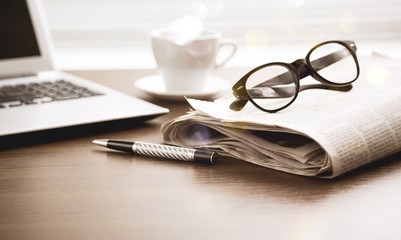 Fototapeta premium Newspaper with computer on table.