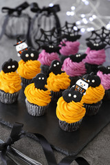 Halloween cupcakes decorated with pumpkin and purple sweet potato and pumpkin fresh whipped cream and black cocoa cookies