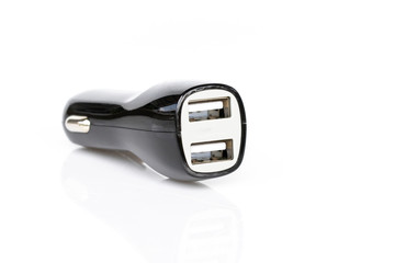 Image of black USB car charger isolated on white background.
