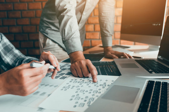 Two software developers are analyzing together about the code written into the program on the computer.