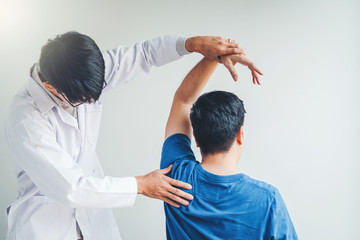 Physical Doctor consulting with patient About Shoulder muscule pain problems Physical therapy diagnosing concept