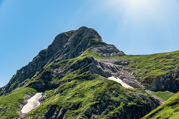 High mountain with green slope.