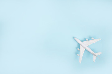 The white plane model on a blue background. Travel Concept.