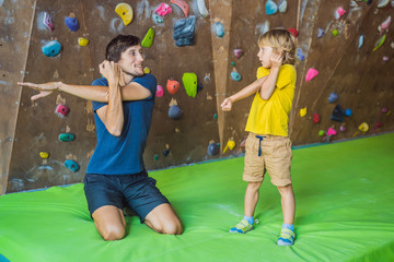 Dad and son at the climbing wall. Family sport, healthy lifestyle, happy family