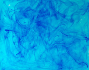 Obraz premium Blurred photo of blue food color drop and dissolve in water for background and texture concept.