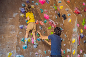 Dad and son at the climbing wall. Family sport, healthy lifestyle, happy family