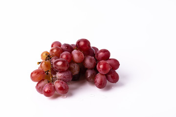 Bunch ripe red grape isolated on white background.