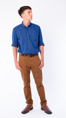 Naklejka premium Full body shot of young handsome businessman thinking and looking away