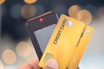 Hand holding of tag queuing to payment food or coffee by credit card.