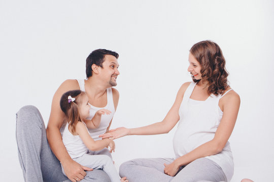 family photo on a white background: parents spend time with their children. mom and dad hug the baby. the concept of childhood, fatherhood, motherhood, IVF