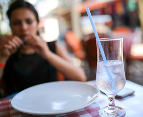 A glass of cold water with ice on the table