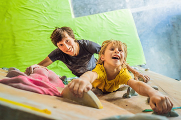 Dad and son at the climbing wall. Family sport, healthy lifestyle, happy family