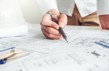 Engineer drawing graphic planning working with architectural project on workplace office.