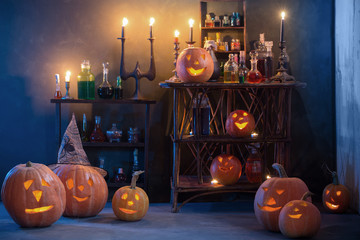 Halloween decoration with pumpkins and magic potions indoor