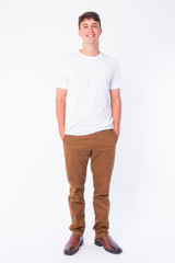 Fototapeta premium Full body shot of happy young handsome man smiling