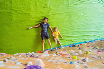 Dad and son at the climbing wall. Family sport, healthy lifestyle, happy family