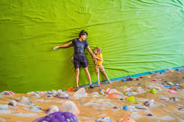Dad and son at the climbing wall. Family sport, healthy lifestyle, happy family