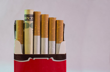 Cigarettes and one hundred dollar American currency.