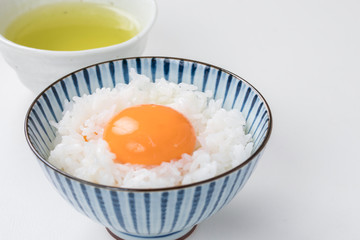 白背景に白ご飯と生卵とお茶　rice egg tea