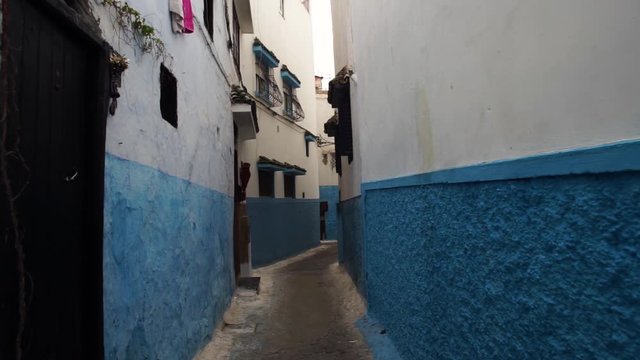 Steadicam shot of a tight street in Chefchaouen city, Morocco