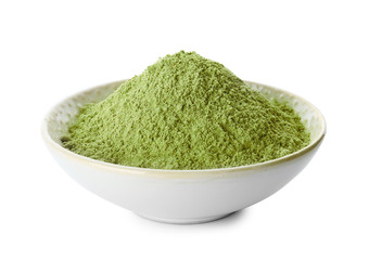 Bowl with wheat grass powder on white background