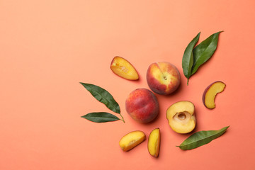 Flat lay composition with sweet juicy peaches and space for text on orange background