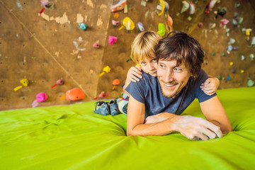 Dad and son at the climbing wall. Family sport, healthy lifestyle, happy family