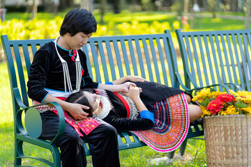 Pretty Young Girlfriend Lying on the Lap of her boyfriend While Relaxing at the Public Park, Mhong couple in valentine day.