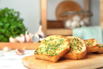 Slices of toasted bread with garlic and herbs on table. Space for text