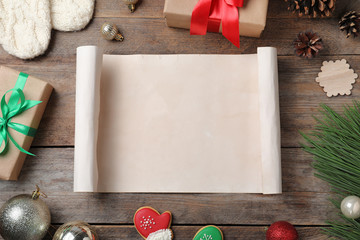 Flat lay composition with empty card and Christmas decorations on wooden table, space for text....