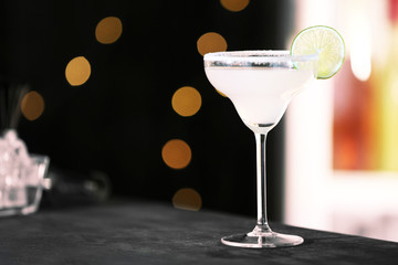 Fresh alcoholic cocktail with lemon and sugar on bar counter, space for text