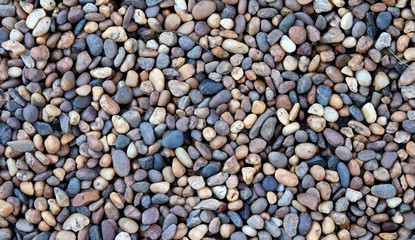 Top view of small stone in the garden, brown and black pebble stones, for texture background.