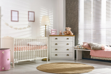 Cozy baby room interior with comfortable crib