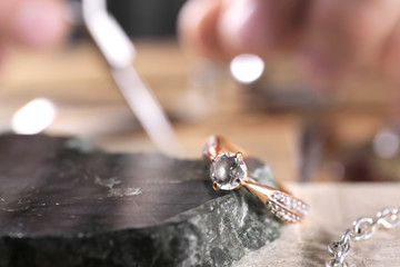 Diamond ring and blurred jeweler on background