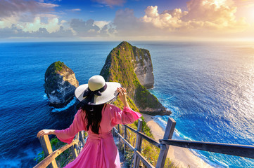 Woman walking at Kelingking Beach in Nusa penida island, Bali, Indonesia.