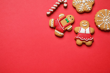 Flat lay composition with tasty homemade Christmas cookies on red background, space for text