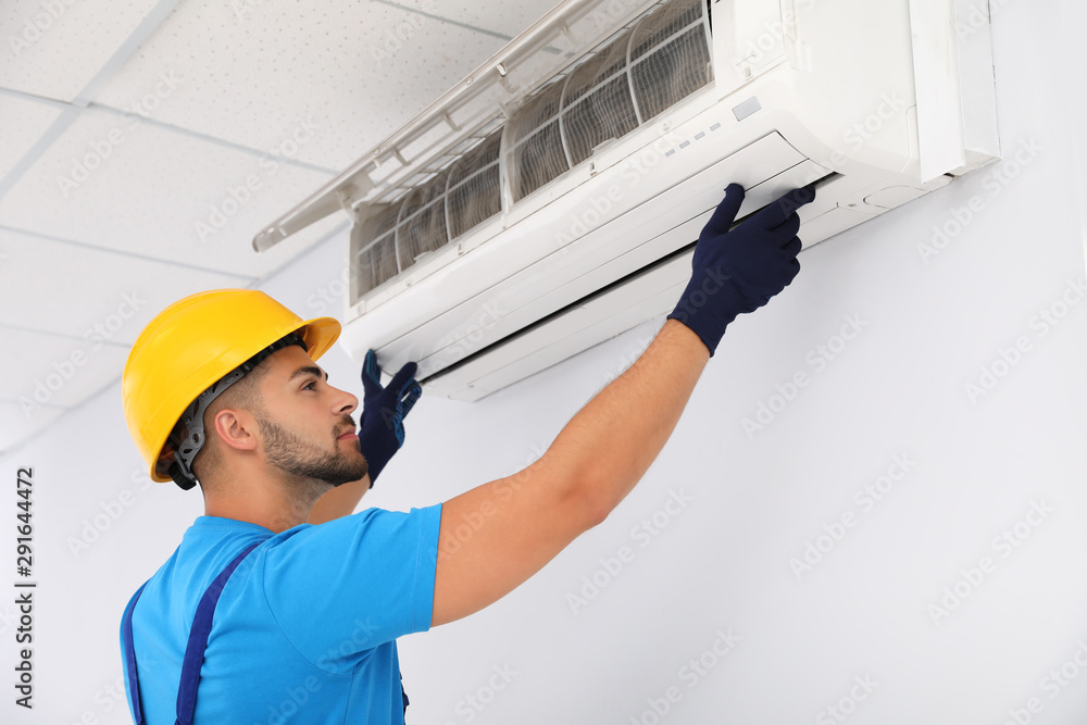 Sticker Professional technician maintaining modern air conditioner indoors