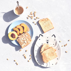 Toast with peanut butter, nectarine and almonds.
