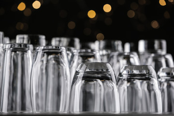Empty glasses on grey table against blurred lights