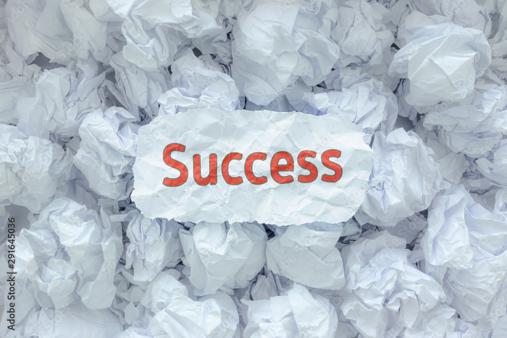 Wall mural the word success is placed on the background paper in the big trash.