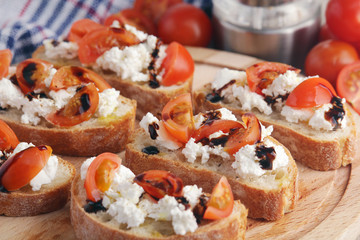 Sandwiches with tomatoes, homemade cheese, olive oil and balsamic sauce