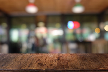 Empty dark wooden table in front of abstract blurred bokeh background of restaurant . can be used for display or montage your products.Mock up for space.
