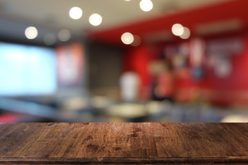 Empty dark wooden table in front of abstract blurred bokeh background of restaurant . can be used for display or montage your products.Mock up for space.